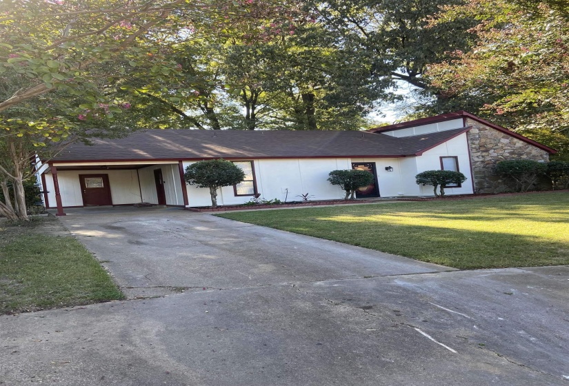 Single-story residence featuring white siding and a brown shingle roof