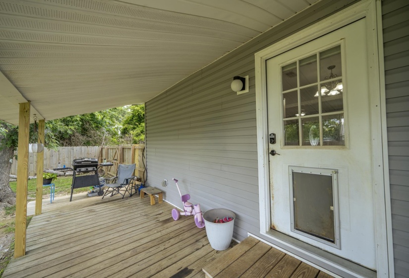 Covered outdoor deck with wood-finish flooring