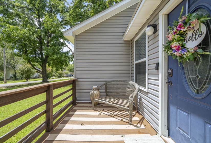 Front porch featuring a blue entry door with an oval leaded glass insert