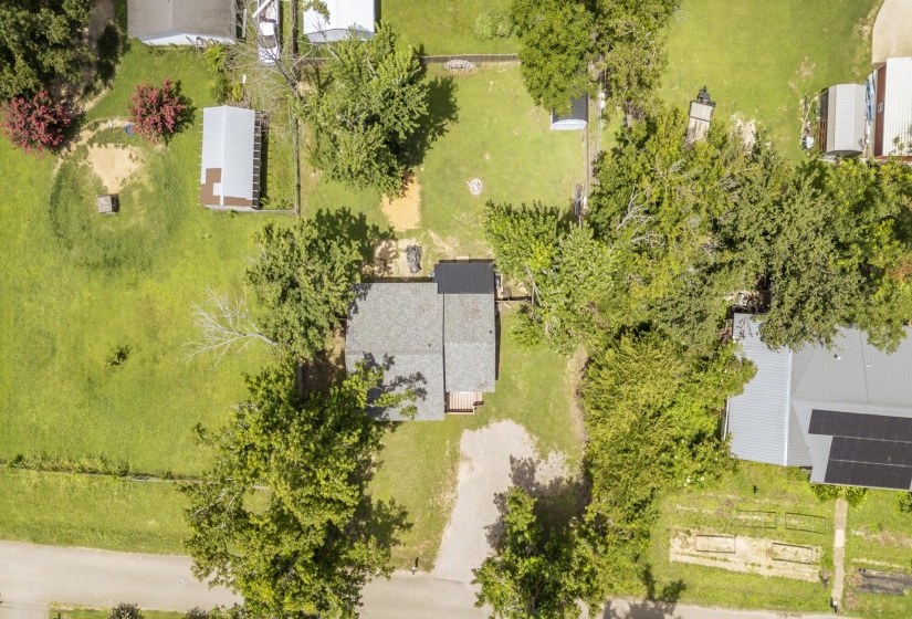 Aerial perspective showcasing the property's footprint, surrounded by mature trees and green space
