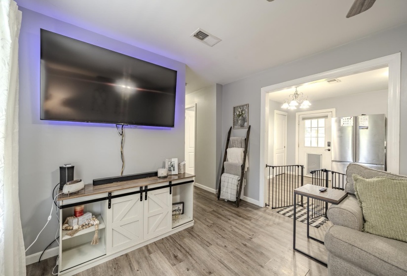 Living area with wood-finish flooring and light gray wall paint