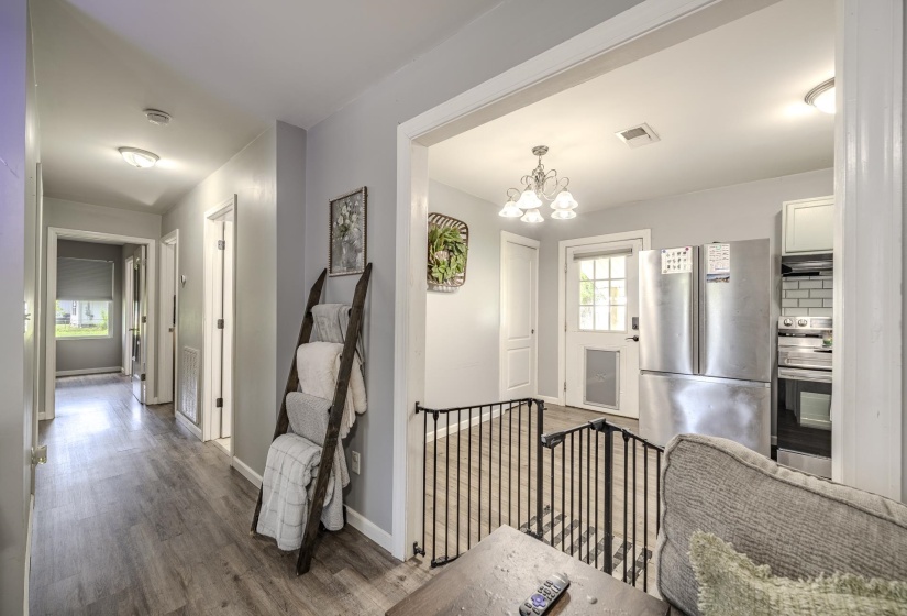 Hallway featuring wood-finish flooring, recessed lighting, and a neutral wall palette