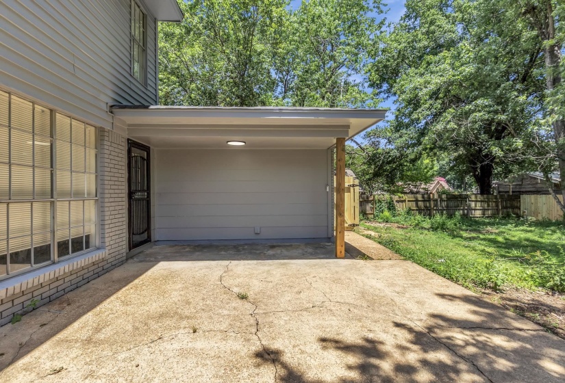 Covered carport with integrated lighting, offering direct access to the property via a secure entry door