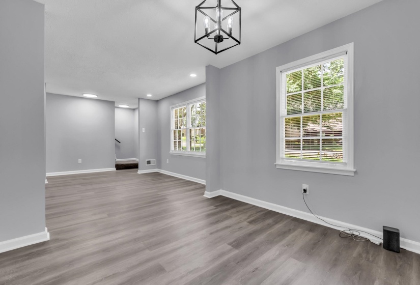 Bright living space featuring wood-finish flooring, light gray walls, and white baseboards