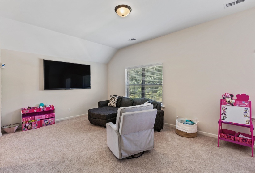 Carpeted room with a tray ceiling and recessed lighting