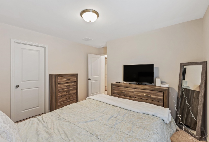 Neutral-toned walls complement the carpeted flooring
