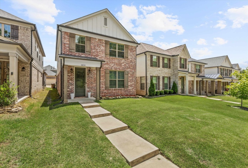 Brick and siding exterior with dark brown shutters