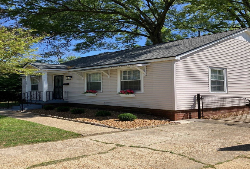 Lawn care is provided with rental. Easy care landscape is fully fenced. Some large trees in backyard.