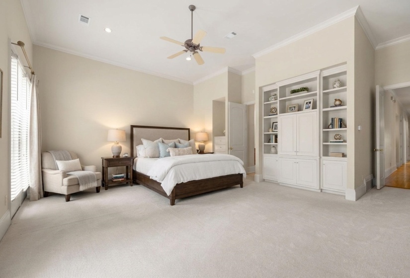 Spacious room featuring vaulted ceilings, a ceiling fan, recessed lighting, and built-in cabinetry with shelving
