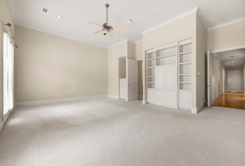 Spacious room featuring light-toned carpeting, a vaulted ceiling, and recessed lighting