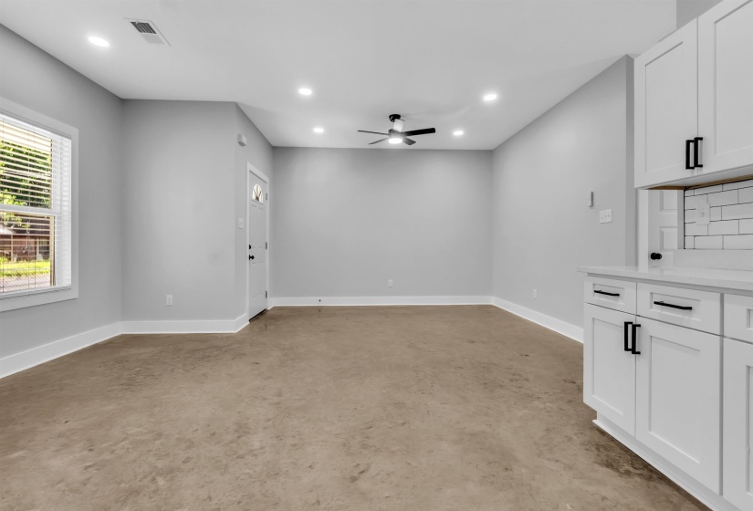 Open concept living space featuring recessed lighting, a ceiling fan, and light gray wall tones