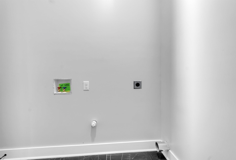 Laundry area featuring a recessed washer box with hot and cold water hookups, a 120V electrical outlet, and a dryer vent
