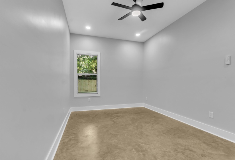 Interior room featuring a ceiling fan with integrated lighting, recessed lighting, and a window with white trim