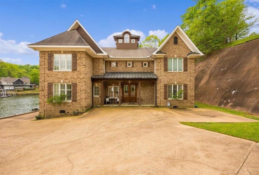 Brick exterior residence featuring multiple gables and a waterside location