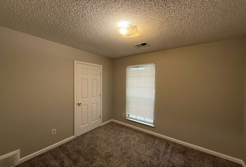 Neutral painted walls complement the textured ceiling