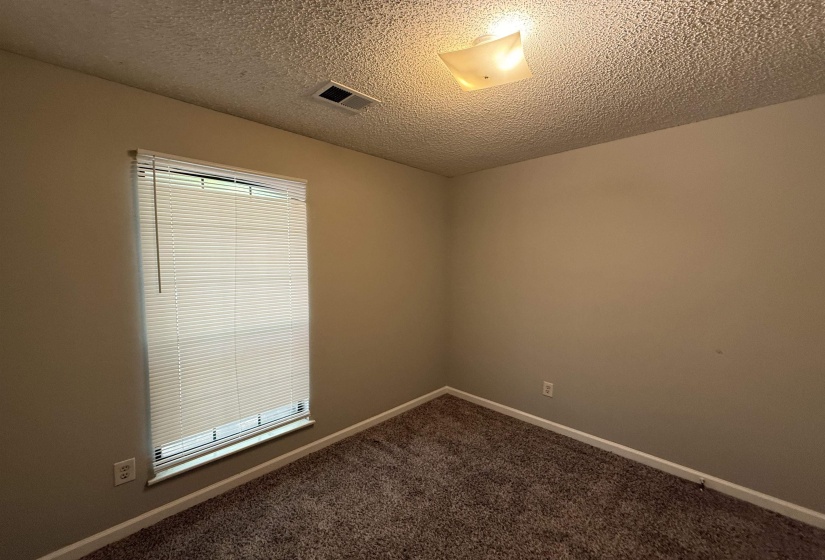Neutral-toned walls complement the textured ceiling