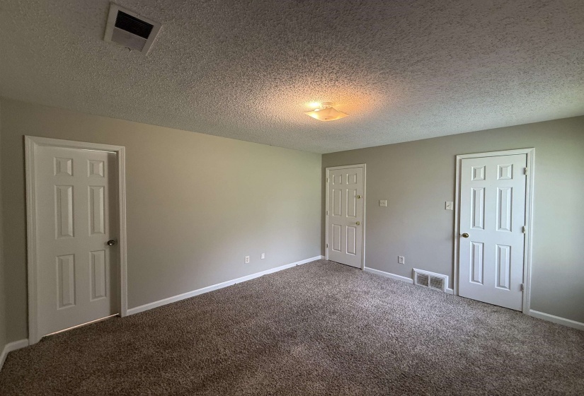 Neutral-toned walls complement the textured ceiling