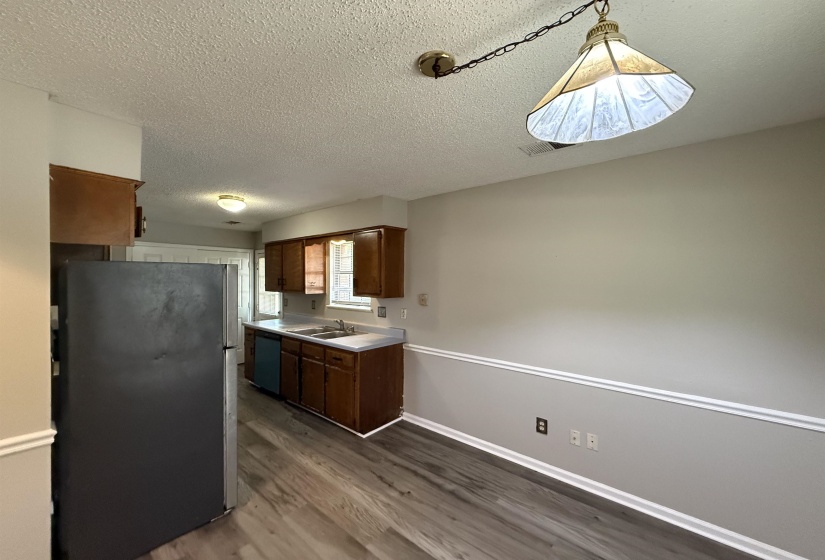 Kitchen with wood-finish flooring, recessed lighting, and a double basin sink