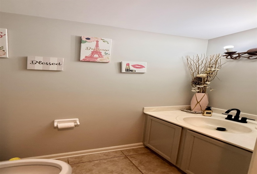 Vanity with an integrated sink and light-toned countertop, set against a neutral wall