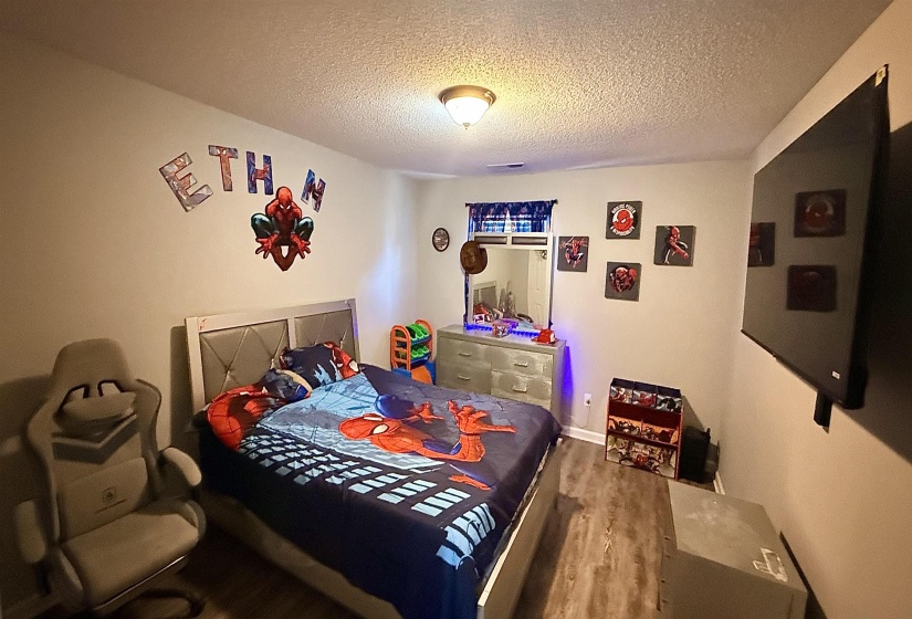 Bedroom featuring wood-finish flooring and light gray wall paint