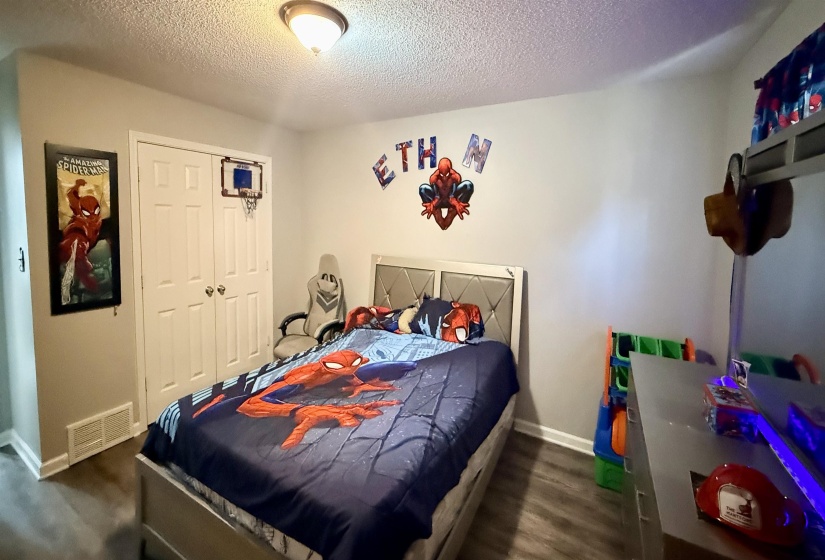 Room featuring wood-finish flooring, white baseboards, and a semi-flush mount ceiling fixture