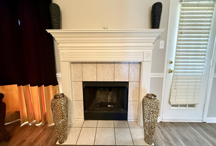 Fireplace with a white wood mantel, tile surround, and a black firebox