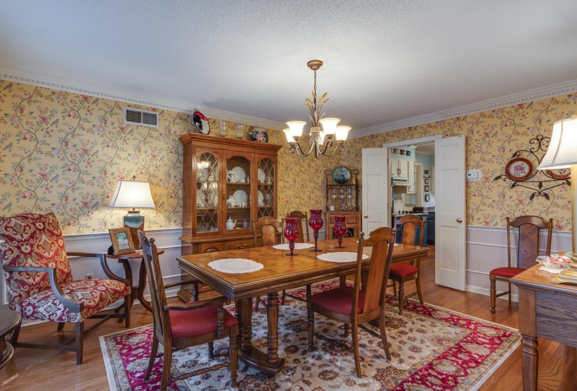 Spacious dining room with bamboo flooring.