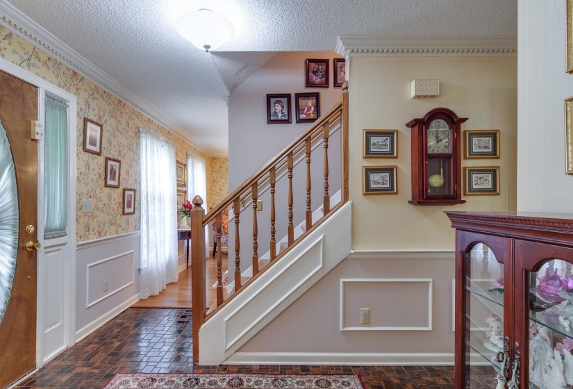 Welcoming entry with tile floor that opens to the dining room to the left , hallway to the kitchen in front and living room to the right.