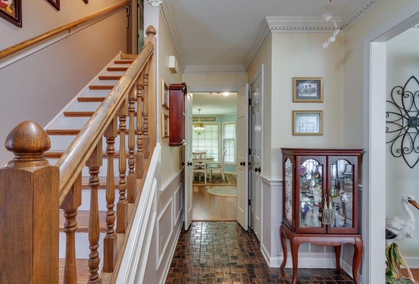 Welcoming entry with tile floor that opens to the dining room to the left , hallway to the kitchen in front and living room to the right.