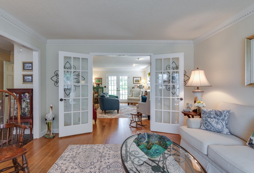 View of Living Room into the Den shows the abundance of living area for family and entertaining.