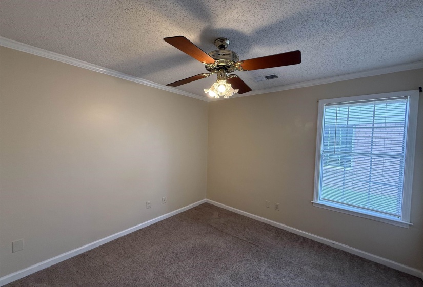 Room featuring neutral wall tones and textured carpeting