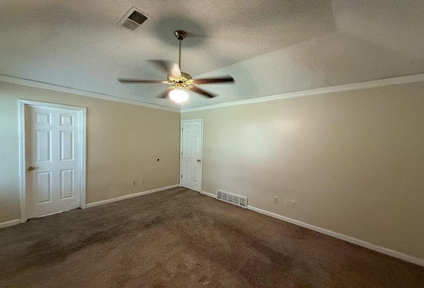 Room featuring neutral wall tones and crown molding