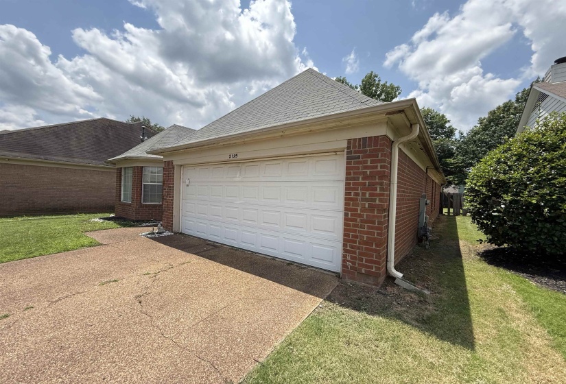 Attached two-car garage with a white paneled door