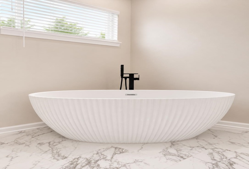Freestanding tub featuring a fluted exterior, accompanied by a matte black floor-mounted faucet and hand shower