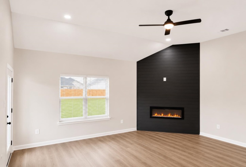 Living area featuring a vaulted ceiling with recessed lighting and a ceiling fan