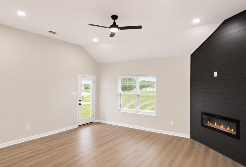 Vaulted ceiling with recessed lighting and a ceiling fan