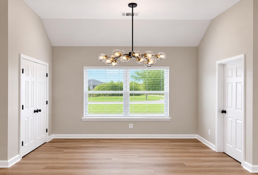 Vaulted ceiling with a modern chandelier featuring clear and amber glass globes