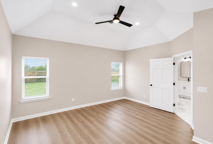 Vaulted ceiling with a ceiling fan and recessed lighting