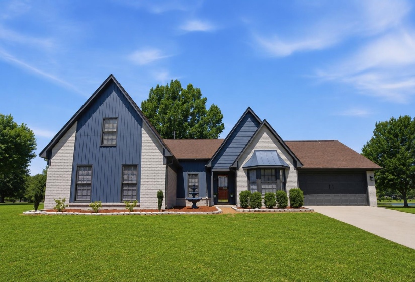Charming exterior featuring a combination of light-colored brick and blue vertical siding