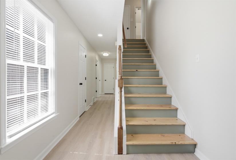 Entryway hallway featuring wood-finish flooring, recessed lighting, and a window with blinds