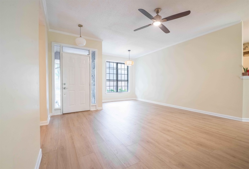 Entryway featuring a paneled door with sidelight windows, overhead transom, and a pendant light fixture