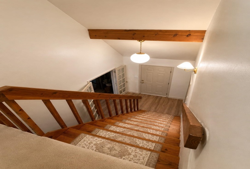 Hardwood staircase with decorative risers and wood railings