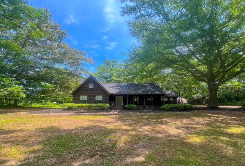 Wood-sided home featuring a prominent peaked roofline and an inviting covered porch