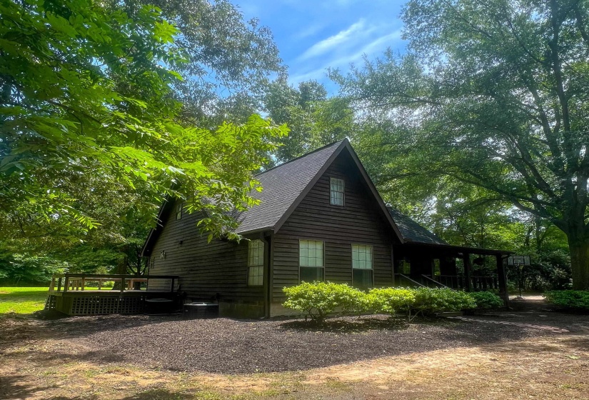 Gable-roof property featuring dark wood siding and a covered front porch