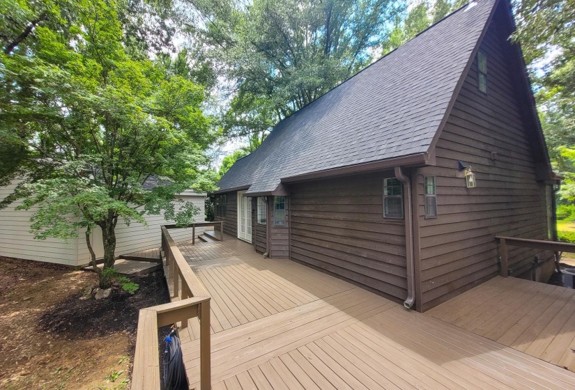 Expansive outdoor deck space featuring wood-finish decking and railings