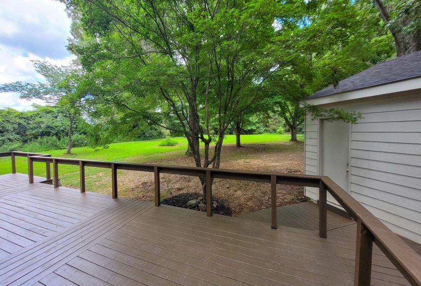 Spacious outdoor deck with a patterned surface and wood-finish railing