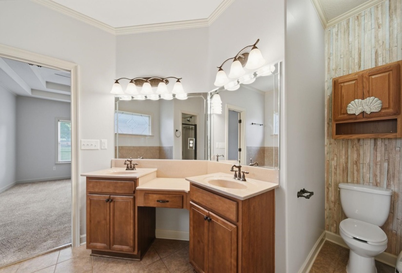Dual vanity with integrated sinks and individual mirrors, featuring warm wood-finish cabinetry
