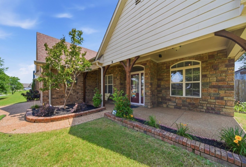 Stone and siding exterior with a covered porch featuring exposed wood beams