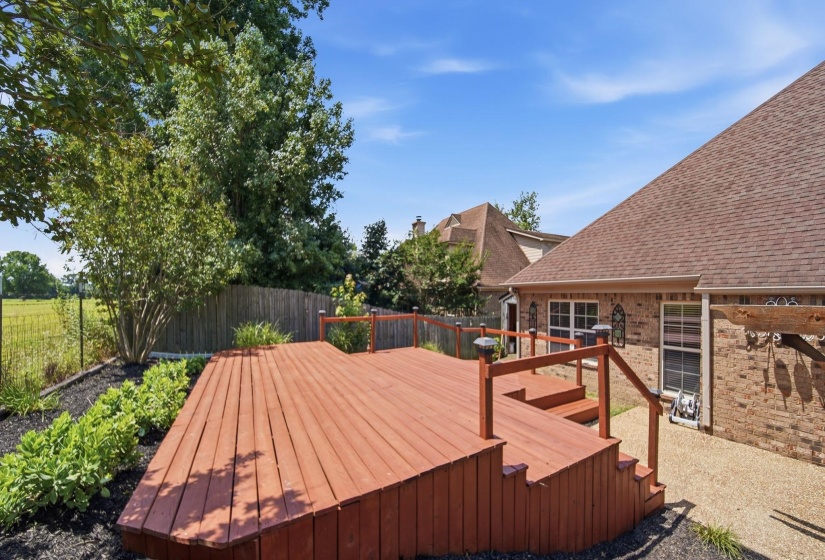 Multi-level wood deck featuring integrated steps and railing