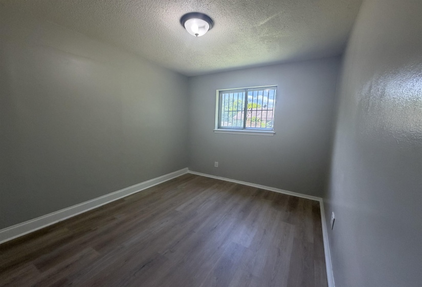 Interior room featuring wood-finish flooring and light gray walls